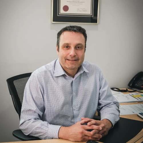 David Martin, Partner at JMG Accounting pictured here smiling in the office